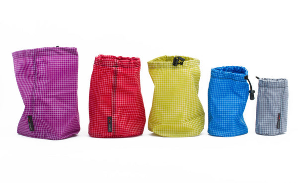 Each size of Travel Stuff Sack in a line from largest to smallest.